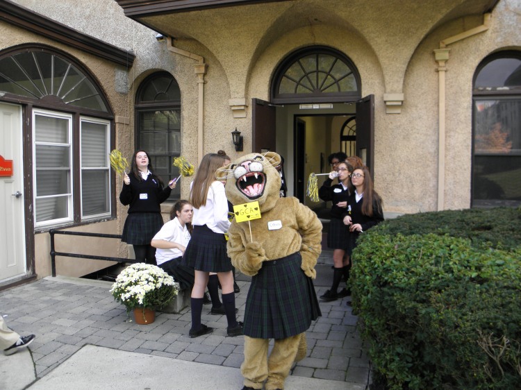 GCA students and their cougar mascot next to the convent